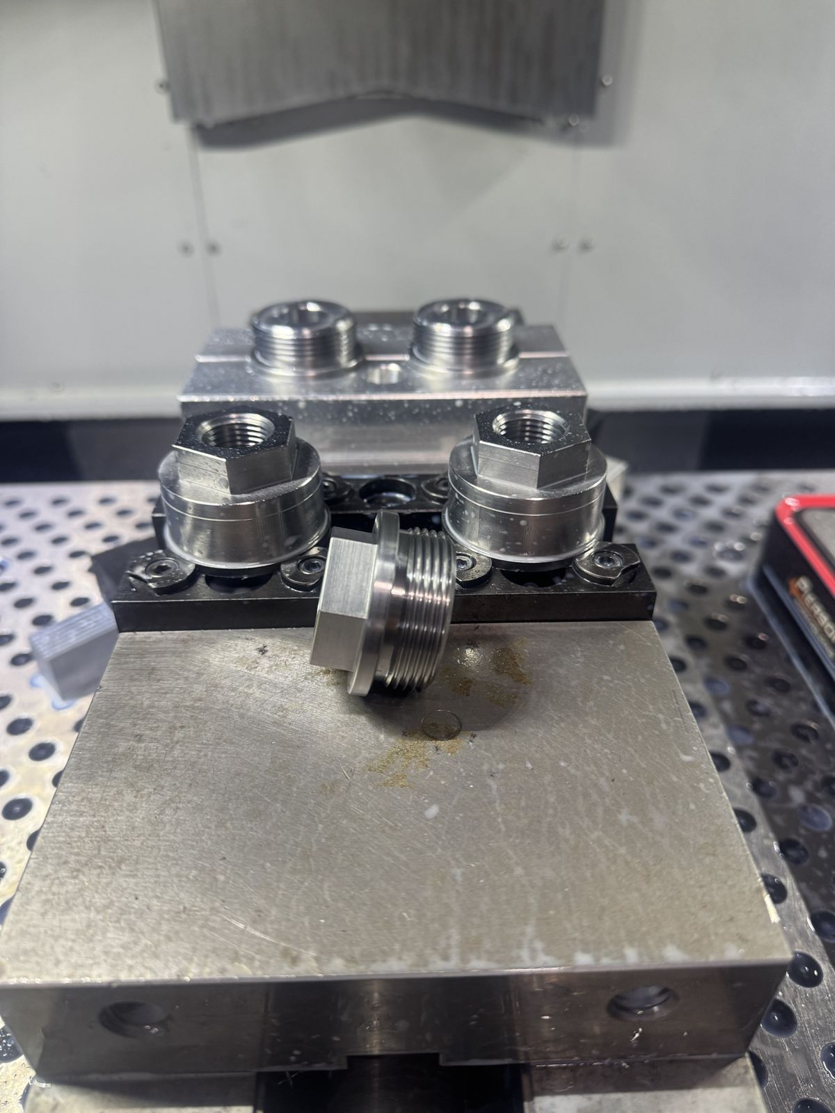 Threaded steel fittings in a vise fixture